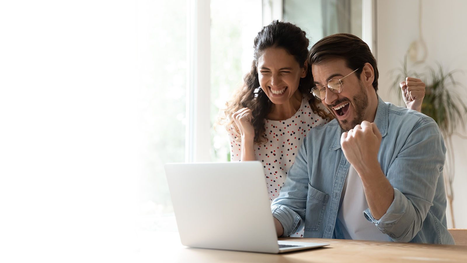 happy couple at a computer